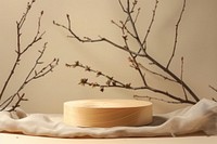 Wood pedestal or board with branches wood blossom cushion.