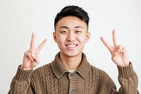 Person making a peace sign finger cheerful portrait.