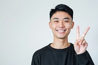 Person making a peace sign portrait finger cheerful.