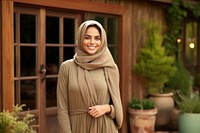 Arab adult woman standing hijab scarf.