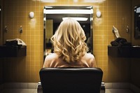 Woman sitting in beauty salon back adult hair.