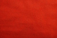Plain fabric texture backgrounds red material.