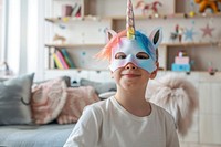 Kid wearing unicorn mask costume representation celebration.