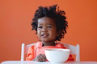African American toddler sitting in a high chair bowl person human.