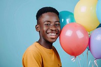 Lovely teenager African boy holding balloons happy dimples person.