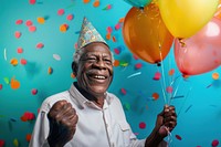 Elderly African man holding balloons happy hat celebrating.