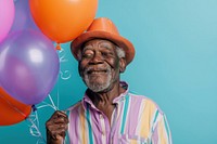 Elderly African man holding balloons happy photo photography.