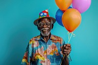 Elderly African man holding balloons happy person human.