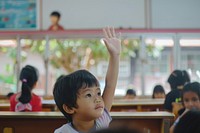 South east Asian kid hand up school architecture building.