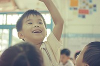 South east Asian kid hand up school happy photo.