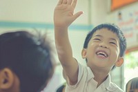 South east Asian kid hand up happy laughing person.
