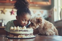 Girl African giving birthday cake dog birthday cake.