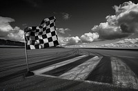 Checkered black and white flag on the wind outdoors airfield asphalt.