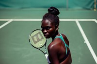 African woman playing tennis shoulder person racket.