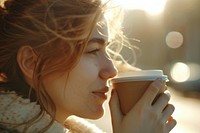 Woman drinking coffee cup smelling beverage.