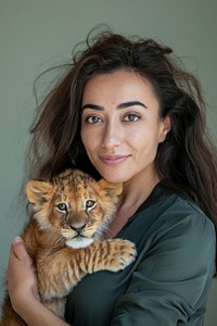 Holding a pet baby lion portrait photo photography.