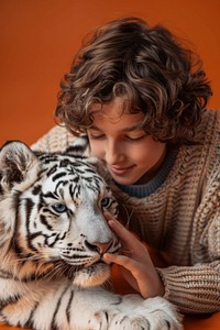 Petting a snow tiger boy wildlife person.