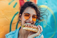 Woman enjoying a hotdog biting adult food.