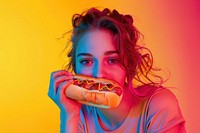 Woman enjoying a hotdog biting eating adult.