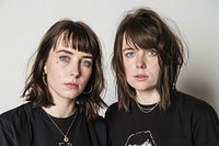 Two women posing for a t-shirt merch drop photoshoot portrait adult individuality.
