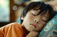 Asian boy looks tired sleeping portrait photo.
