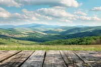 Wooden table background on a blur high green hills mountain wood countryside vegetation.