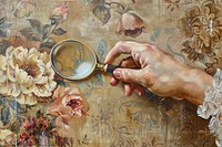 Close up on pale hand hold magnifying glass painting accessories accessory.