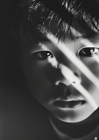 Analog black and white film photography of an asian kid portrait worried person.