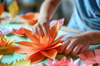 Kid making paper flower hand art handicraft.