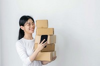 Happy woman holding stack box cardboard phone mobile phone.
