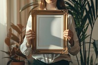 Holds an vintage photo frame mockup painting person human.