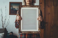 Holds an vintage picture frame mockup art painting person.