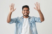 Young indian man waving hand smile triumphant person.