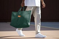 Man using green tote bag, eco-friendly product