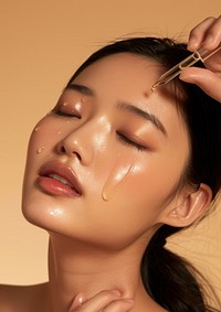 South East Asian woman applying facial serum drops cosmetics person female.