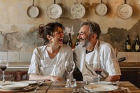 An Italian chef and his wife laughing plate countryside.
