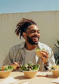 A photo of happy man eating laughing person human.