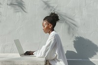 Black woman computer sitting laptop.