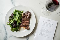 A restaurant menu plate food beef.