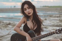 South east asian woman guitar playing guitar recreation.