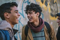 Happy middle eastern laughing with teenage male friends happy clothing apparel.