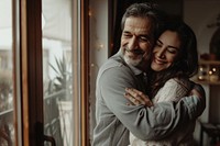 Middle Eastern Smiling mid adult couple hugging each other happy man person.