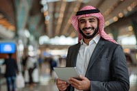Smiling Young Middle eastern With Digital Tablet In Hands Posing At Airport Terminal computer man accessories.