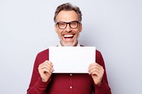 Man holding a picture of a mouth smiling surprised laughing document.