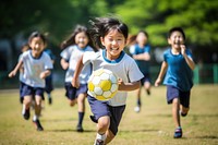Diverse school kids playing soccer football clothing footwear.