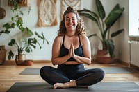 A happy chubby woman do yoga at home exercise sports adult.