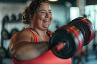 A happy chubby woman workout with drumbell in hand gym exercise sports.