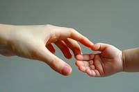 Baby hand in mother hand finger togetherness handshake.