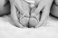 Baby feet in mother hands baby finger beginnings.