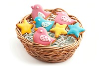 A basket with bird cookies and star cookies for children food white background representation.
